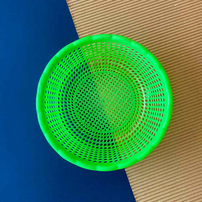 Daily Dump Plastic Sieve top view on a corrugated background